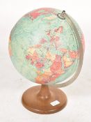 A vintage mid 20th century desk top scan globe set to a circular wooden base.