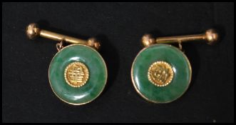 A pair of vintage Chinese 18ct gold and jade cuffs / cuff links of roundel form having ball ended