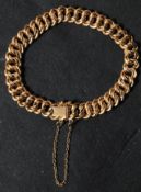 An 18ct carat gold ladies vintage bracelet chain having a fancy engraved link design with hidden