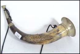 An Ancient Order of Foresters Hunting Horn, with brass mounts, set with a brass AOF badge, with