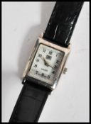A vintage 20th century silver cased art deco wrist watch.The case of square form with silvered dial.