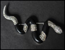 A 925 silver figural brooch in the form of  a snake set with marcasite having a roller clip clasp.