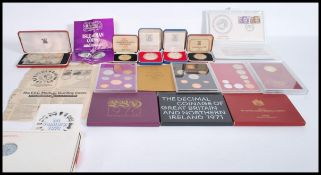 A collection of vintage Royal mint coins to include two sterling silver 1977 crowns in