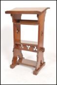 An early 20th century gothic eclesiastial lecturn of peg jointed construction, pierced stretcher