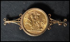 A 1966 Queen Elizabeth II full gold sovereign set to a scrolled 9ct gold bar brooch mount bearing