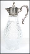 A 20th century silver plated and cut glass claret jug. The silver plated mounts having gadrooned