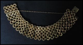 An 18ct gold ladies bracelet having strands of hoop links with a hidden clasp and safety chain.