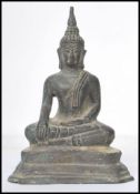 A 19th century Oriental Chinese bronze Buddha modelled in the lotus position raised on a pedestal