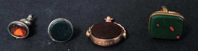 A group of vintage 20th century intaglio fob pendants to include a hallmarked 9ct gold example