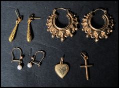 A group of 9ct gold earrings and pendants to include a fancy loop pair, an engraved drop pair, pearl