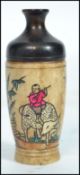A 19th century Oriental Chinese horn perfume bottle having character marks depicting scenes of a
