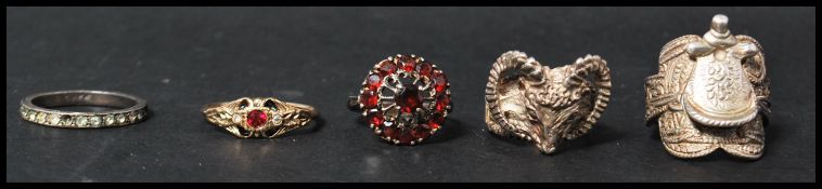 A group of vintage rings to include a large silver harvest buckle ring, a silver rams head ring, a