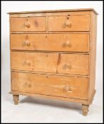 A 19th century Victorian scrubbed pine two short over two long chest of drawers, turned handles
