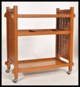 A vintage mid 20th century retro danish influence teak trolley with sliding removable trays raised