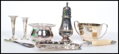 A collection of silver and silver plated items to include a plated wine bottle coaster with