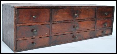 An 18th century Georgian desk tidy of oak construction. The three long drawers having a bank of