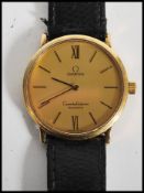 A vintage 20th century Omega Constellation swiss made wrist watch. The gilt dial having baton and