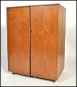 A Vintage mid century Danish influence teak wood mid century metamorphic cabinet desk having