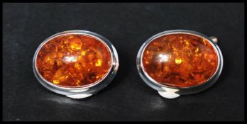 A pair of 925 silver cufflinks set with amber style cabochons. Marked 925.