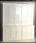 An impressive 19th century Victorian painted pine housekeepers cupboard. The base with large
