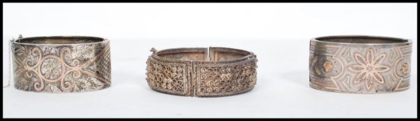 A group of three silver bangles to include a pair of 19th century hallmarked silver Victorian