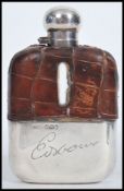 A silver hallmarked leather and glass hip flask by James Dixon & Sons bearing Sheffield hallmarks,