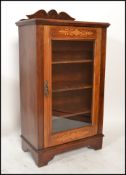 A Victorian mahogany and marquetry inlaid pier cabinet. Raised on plinth base with single door