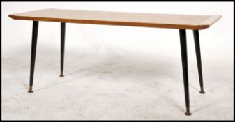 A vintage / retro long teak wood coffee table dating to the mid 20th century raised on ebonised
