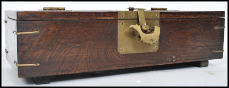A vintage 20th century Oriental Chinese wooden box having brass hinge and lock. The lid opening to