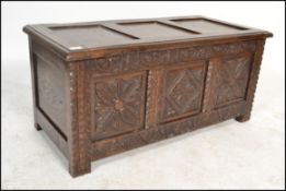 An early 20th century Jacobean revival carved oak coffer chest. The front with carved geometric