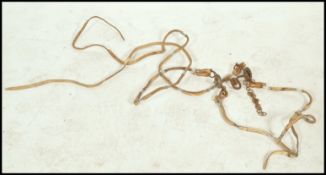 An unusual late 19th / early 20th century horse riding bridle / reigns. Decorative white leather,