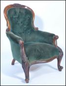 A Victorian mahogany spoon back library chair, with button back green velour upholstery, pad seat