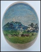 A 19th / 20th century Ostrich egg with a hand painted mountain scene to the front of possibly