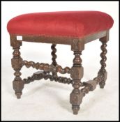A Victorian barley twist footstool raised on barleytwist supports united by stretchers having an