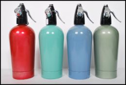 A group of four vintage retro 20th century Sparklet's soda siphons to include red, blue, light