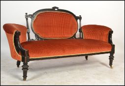 A Victorian mahogany aesthetic movement loving sofa - chesterfield settee. Ebonised with gilt