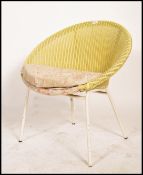 A vintage mid century rattan weave style bedroom chair in yellow colourway with fabric cushion