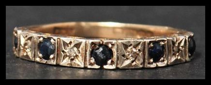 A vintage mid 20th century hallmarked 9ct gold seven stone diamond and sapphire ring. The diamonds
