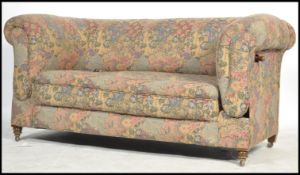 A Victorian mahogany tapestry upholstered drop arm