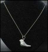 A 925 silver pendant necklace strung with a figural whistle pendant of a bird strung on a rope twist