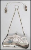 A vintage early 20th century silver plated ladies purse with fitted sectional green velour