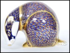 A Royal Crown Derby Badger paperweight, with red stamp to underside, gold stopper, 7cm high