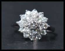 A contemporary  ladies 20th century 18ct white gold diamond cluster ring, together with valuation