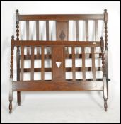 An Antique Edwardian oak barleytwist double bed having slatted head and footboard united by the