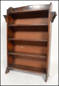 A 1900's Arts & Crafts oak peg jointed open window bookcase cabinet having fixed bank of shelves