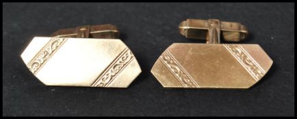 A pair of hallmarked 9ct gold of larger form of oblong shape having engraved decoration. Weighs 11.2