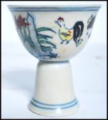 A 19th century Oriental Chinese sake cup depicting flowers with concentric blue circles and blue