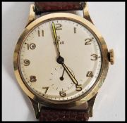 A vintage 20th century Tudor Rolex wrist watch having a silvered dial with gilt numerals, faceted