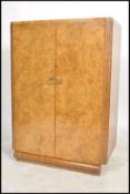 A 1930's Art Deco walnut linen press cupboard. Of low form with shaped plinth  base. Above an