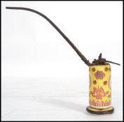 An early 20th century Chinese ceramic water opium pipe having a ceramic body with a famille jaune